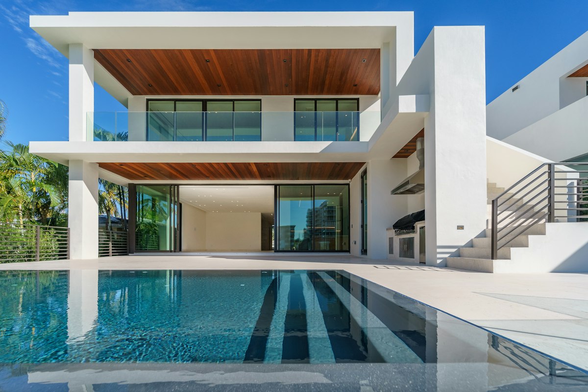 Contemporary courtyard residence with floor-to-ceiling glass, natural wood and a private pool
