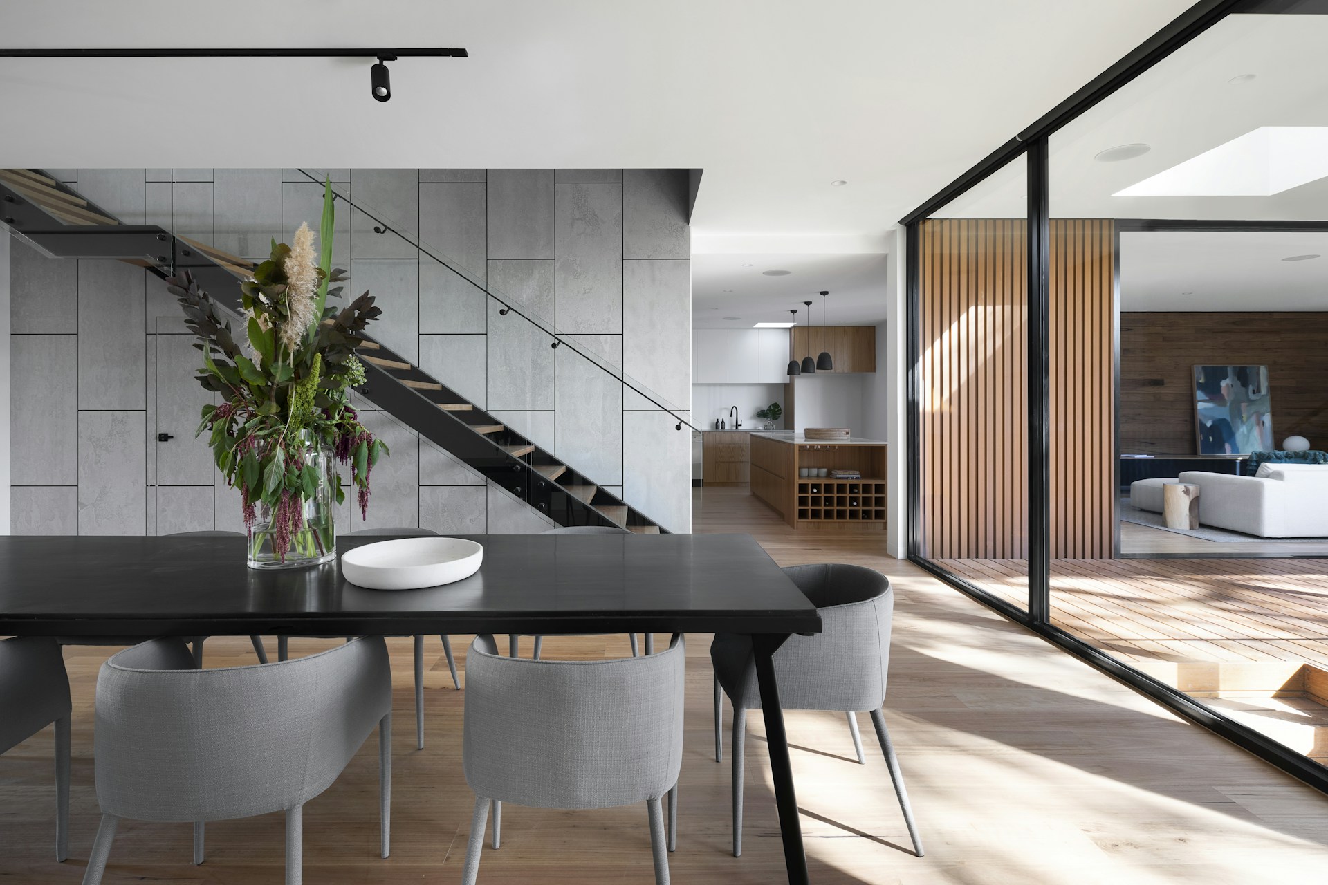 Contemporary home with bespoke woodwork, glass walls and a sculptural staircase